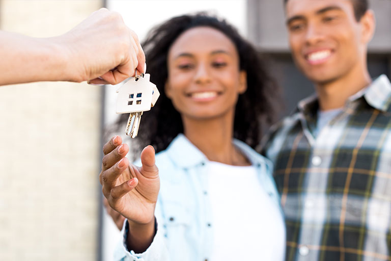 Landlord handing over keys to tenants at a rental property in Norwich